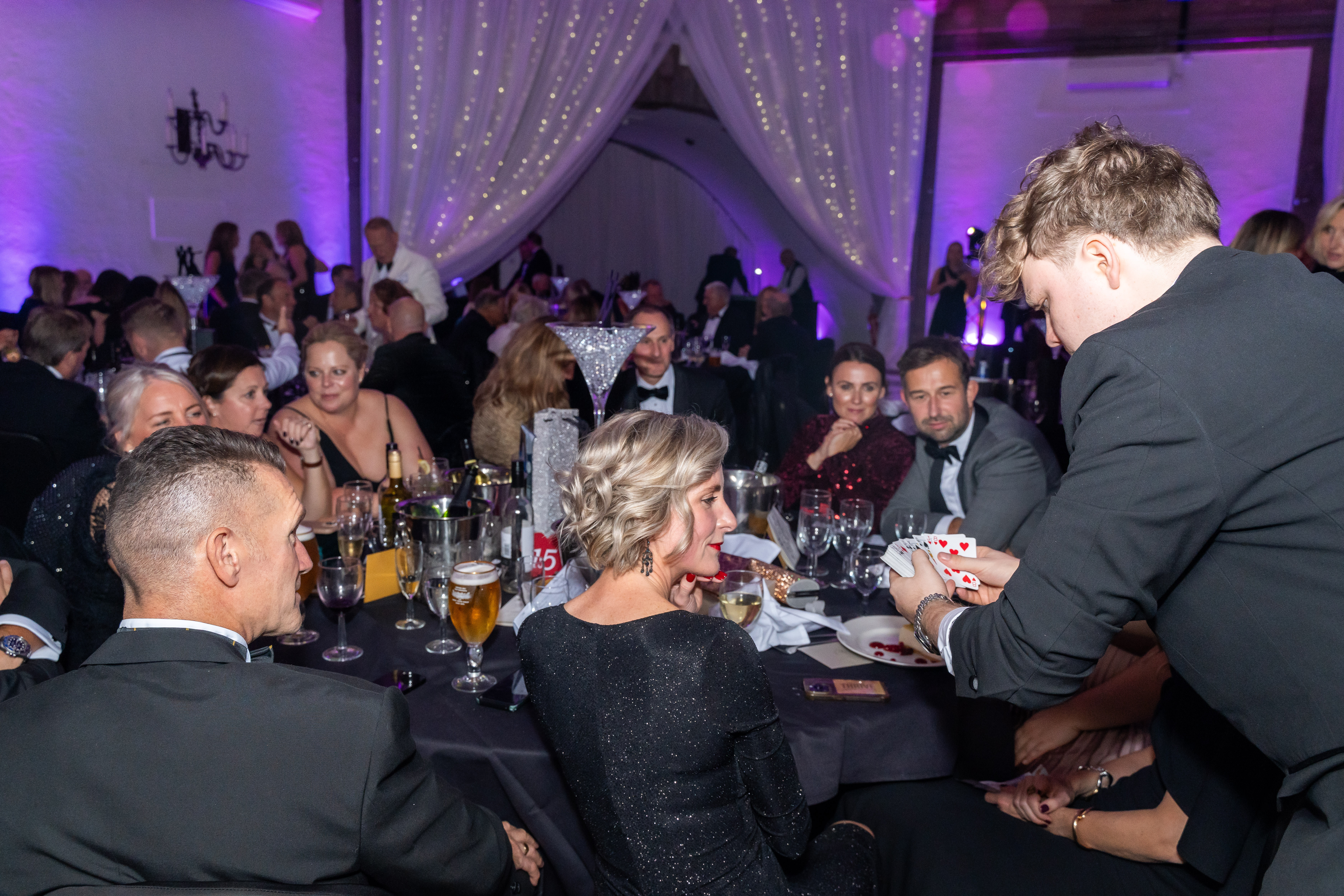 Julius Oefelein performing close up magic for guests at an event
